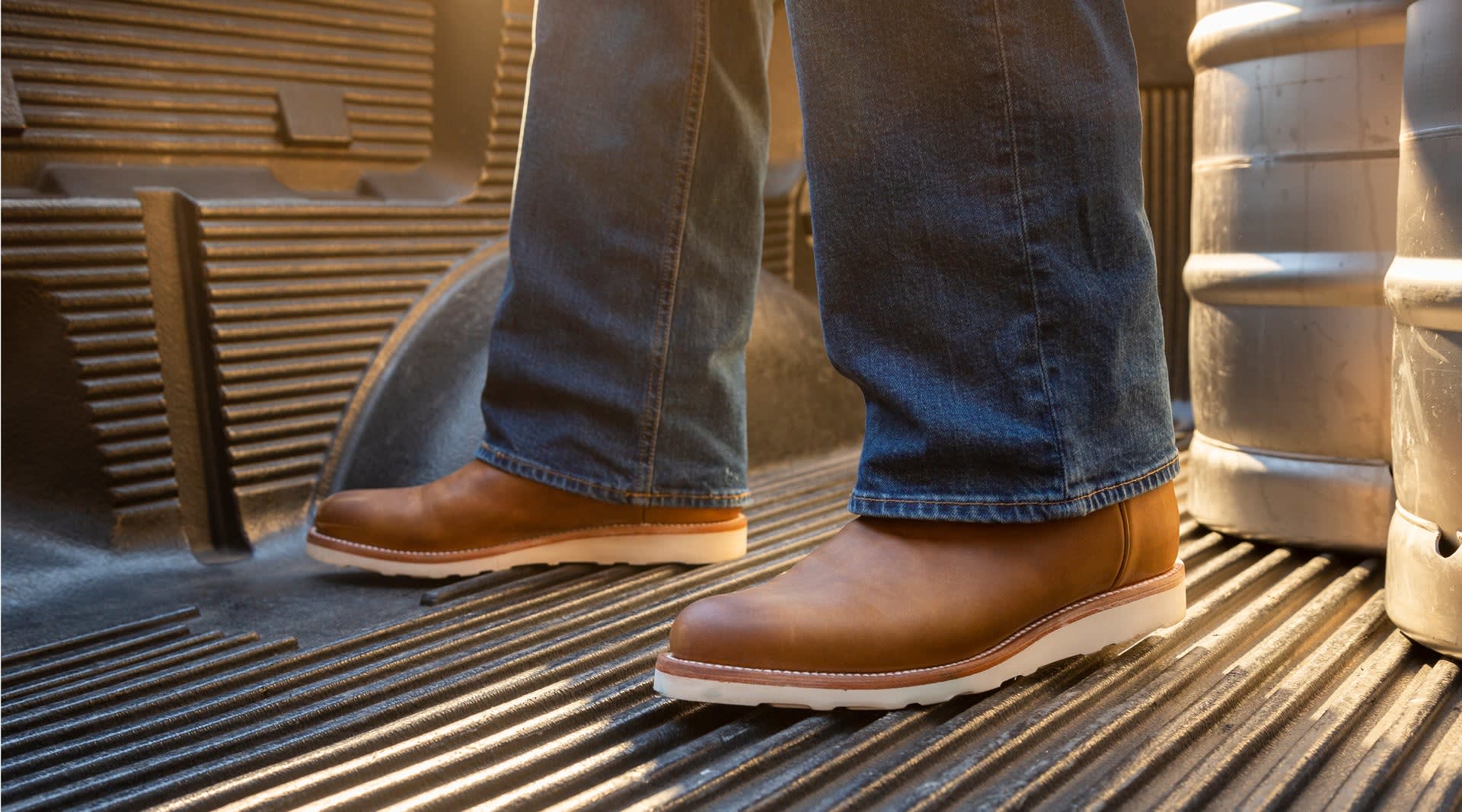 man in boots and jeans standing 